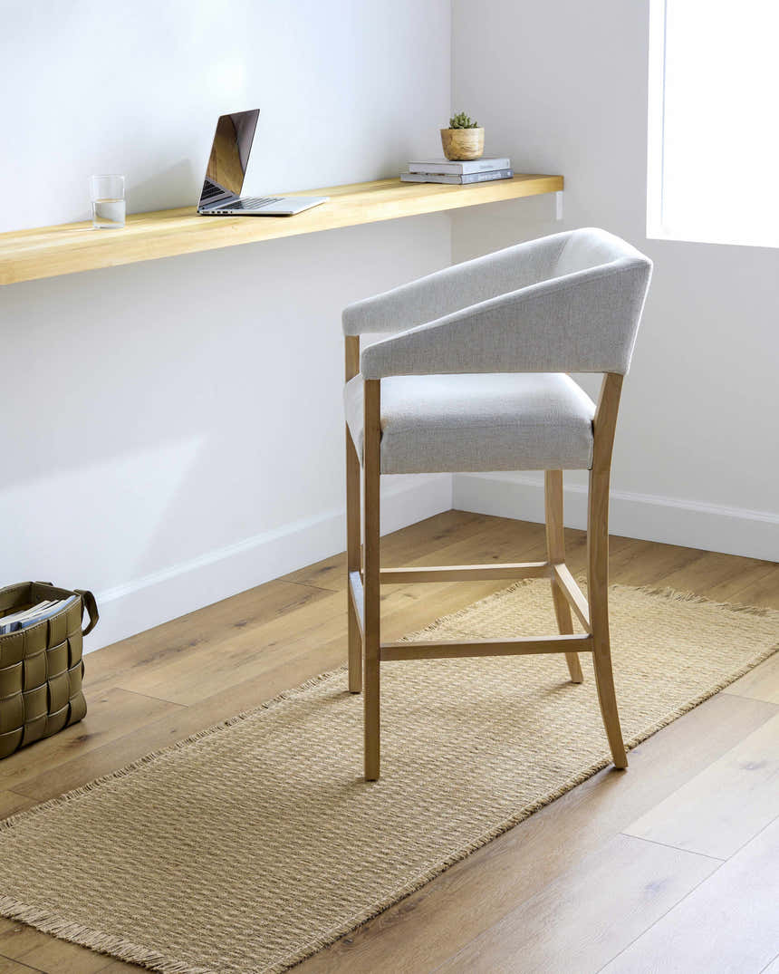 Light brown Kimi Machine Woven runner rug in a bright, minimalist office space with a light wood desk and chair. Roomscene-Runner
