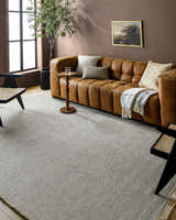 Living room with a brown leather sofa and Kimi Machine Woven Becki Owens rug in gray and light brown. Roomscene-Rectangle