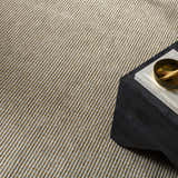 Close-up of the Kimi Becki Owens x LIVABLISS rug. Gray and light brown jute with a woven texture. Styleshot
