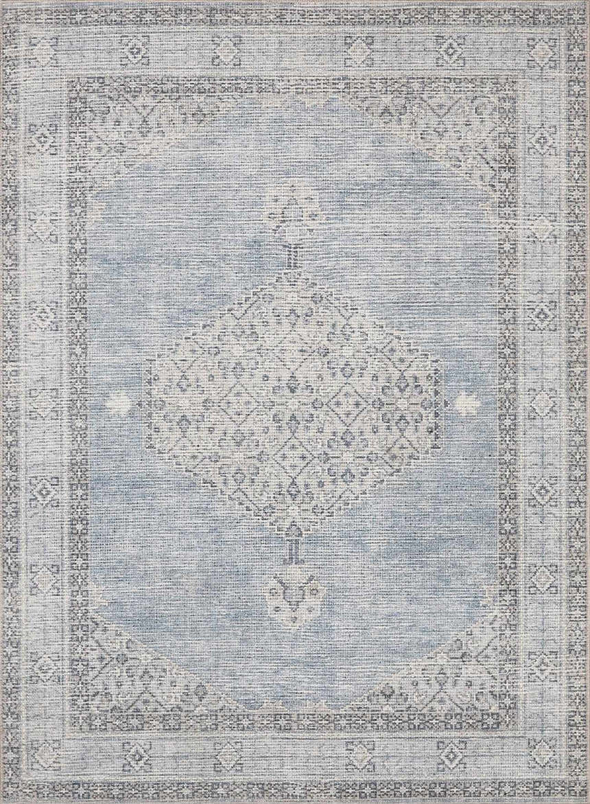 Close-up of Lila Medallion Denim Area Rug. Features a traditional medallion pattern in charcoal, gray, and denim blue hues. Design-Rectangle