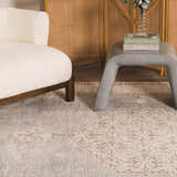 Styled living room scene with a Lila Medallion Denim Area Rug, cream chair, gray accent table, and woven screen. Roomscene-Rectangle