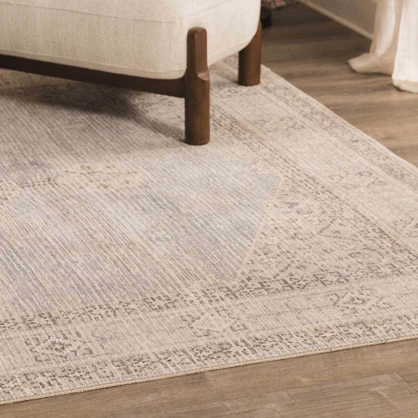 Close-up of the Lila Medallion Denim Area Rug showing its traditional pattern and soft gray, brown, and nutmeg colors. Roomscene-Rectangle