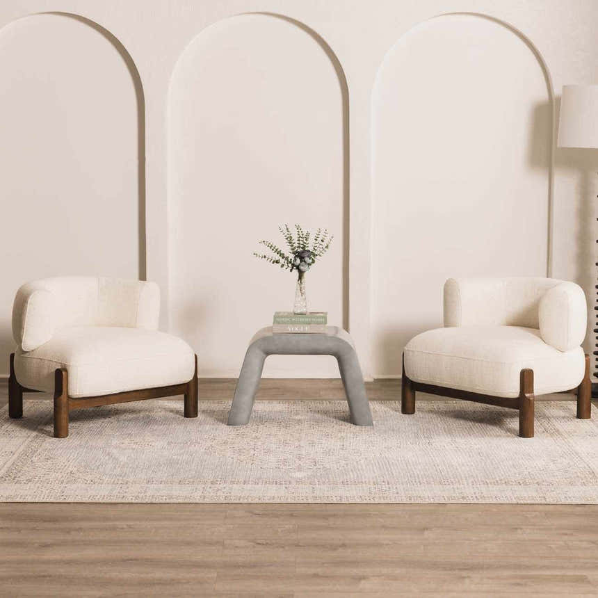 Living room scene with two cream chairs on a Lila Medallion Denim Area Rug with a gray table between them. Roomscene-Rectangle
