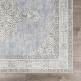 Close-up of the Lila Medallion Denim Area Rug. Farmhouse style rug with charcoal, gray, and nutmeg medallion pattern. Swatch