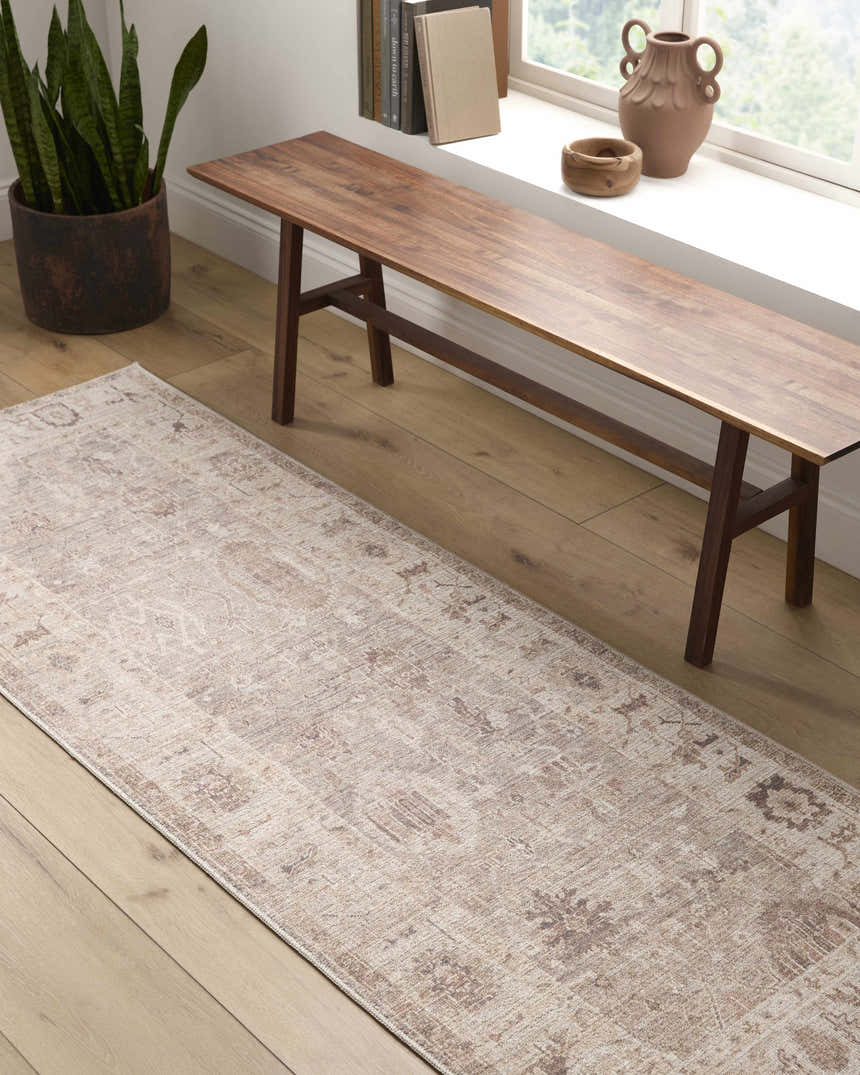 Hallway scene with a beige and chestnut Matat Area Rug, wood bench, and potted plant. Roomscene-Runner