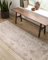 Hallway scene with camel and brown Marlene Becki Owens x LIVABLISS rug, wood bench, plant, and natural light. Roomscene-Runner