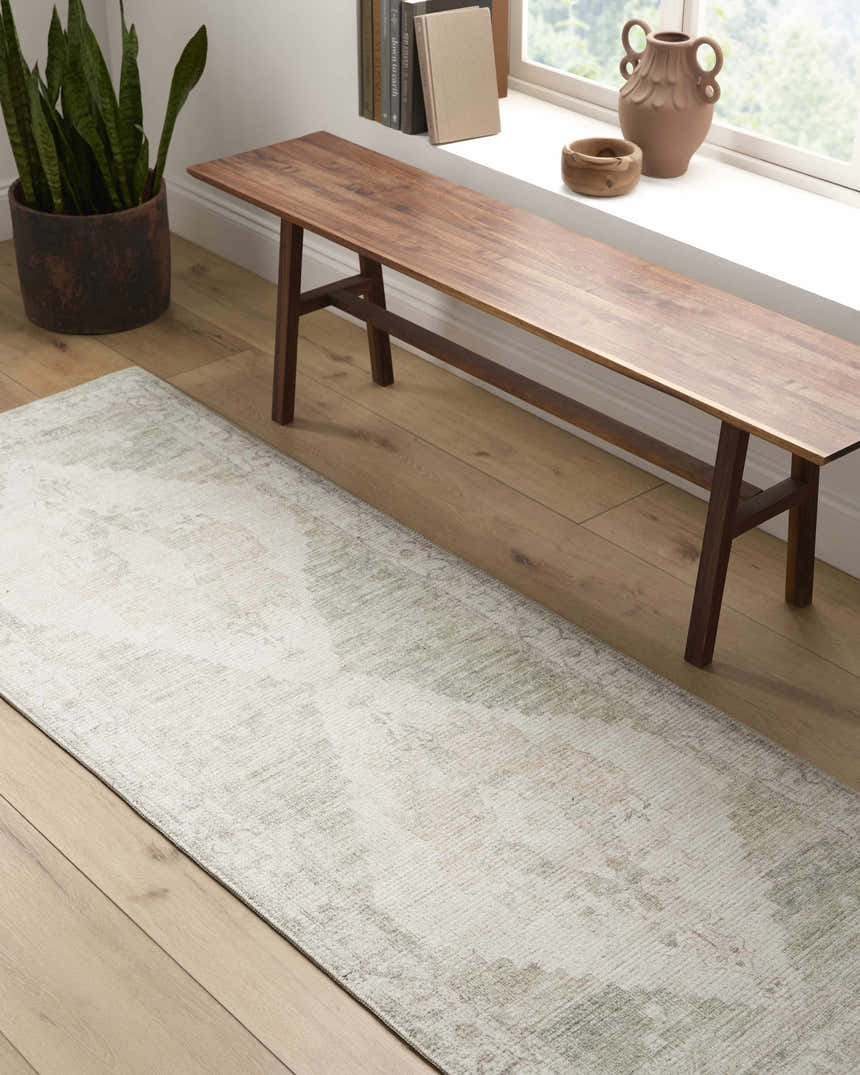 Hallway scene with a Luca Medallion Olive Area Rug, wooden bench, potted plant, and natural light from a window. Roomscene-Runner