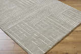 Close-up of the Akuji Area Rug showing its gray wool texture and contemporary white geometric line pattern. Corner