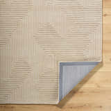 Close-up of the hand-tufted Citro Ivory Area Rug. Contemporary wool rug with a geometric maze pattern. Fold
