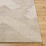 Close up of the Citro Ivory Area Rug showing its geometric pattern and wool texture on a wood floor. Front