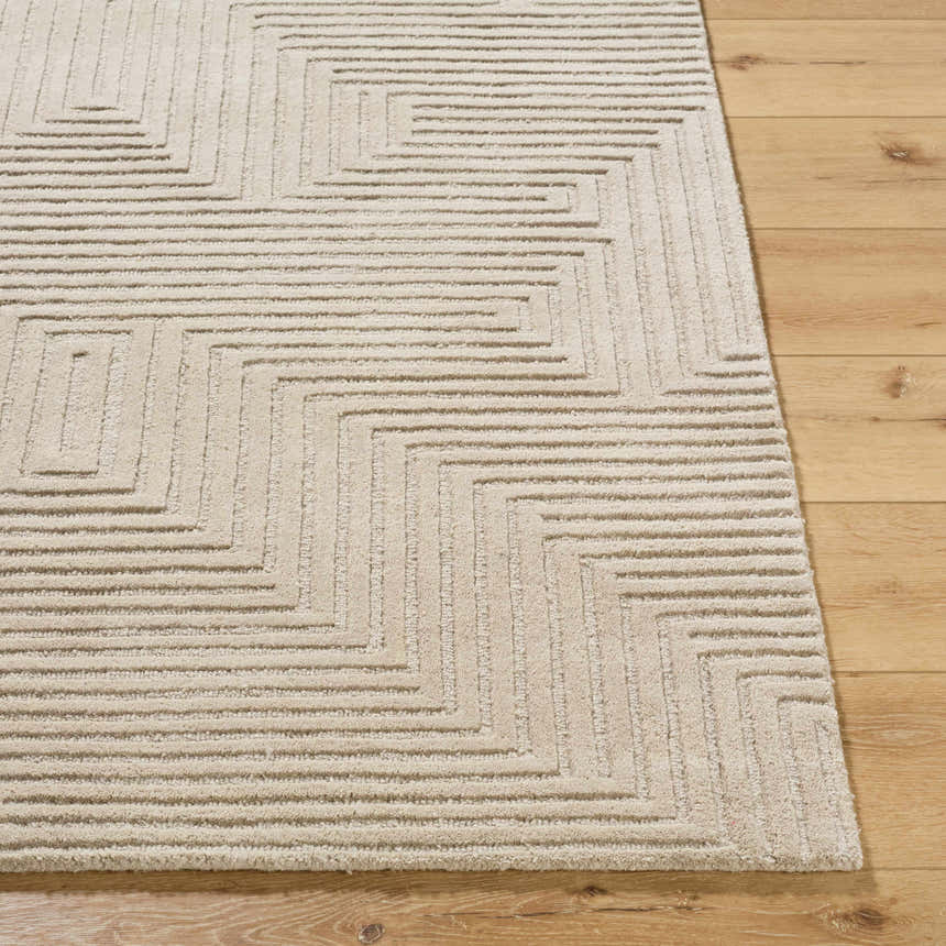 Close up of the Citro Ivory Area Rug showing its geometric pattern and wool texture on a wood floor. Front