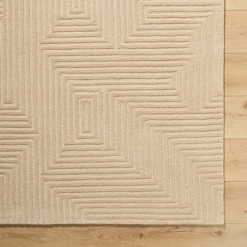 Close-up of the hand-tufted Citro Beige Area Rug showing geometric pattern and textured wool on a wood floor. Corner