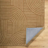 Close-up of the hand-tufted Whan Camel Area Rug showing its geometric pattern and texture. 100% Wool rug with folded corner. Fold