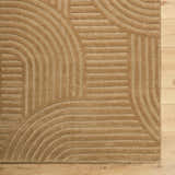Close-up of the hand-tufted Whan Camel Area Rug showing its contemporary geometric pattern and soft wool texture. Corner