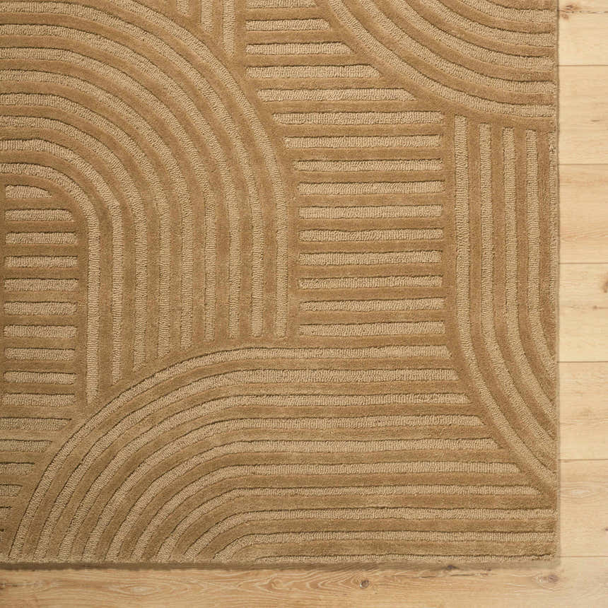 Close-up of the hand-tufted Whan Camel Area Rug showing its contemporary geometric pattern and soft wool texture. Corner