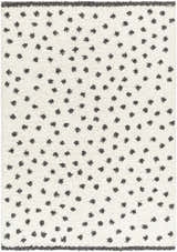 Close up of Chaia Dotted Black & White Plush Rug. Shag rug with black dots on a white background. Contemporary style. Design-Rectangle-537