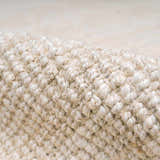 Close-up of the hand-woven Ambel Cream Jute Rug showing its natural jute texture and bone color. Fold