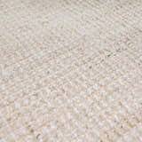 Close-up of the hand-woven Ambel Cream Jute Rug. Bone and beige tones highlight the rug's texture and natural jute fibers. Texture