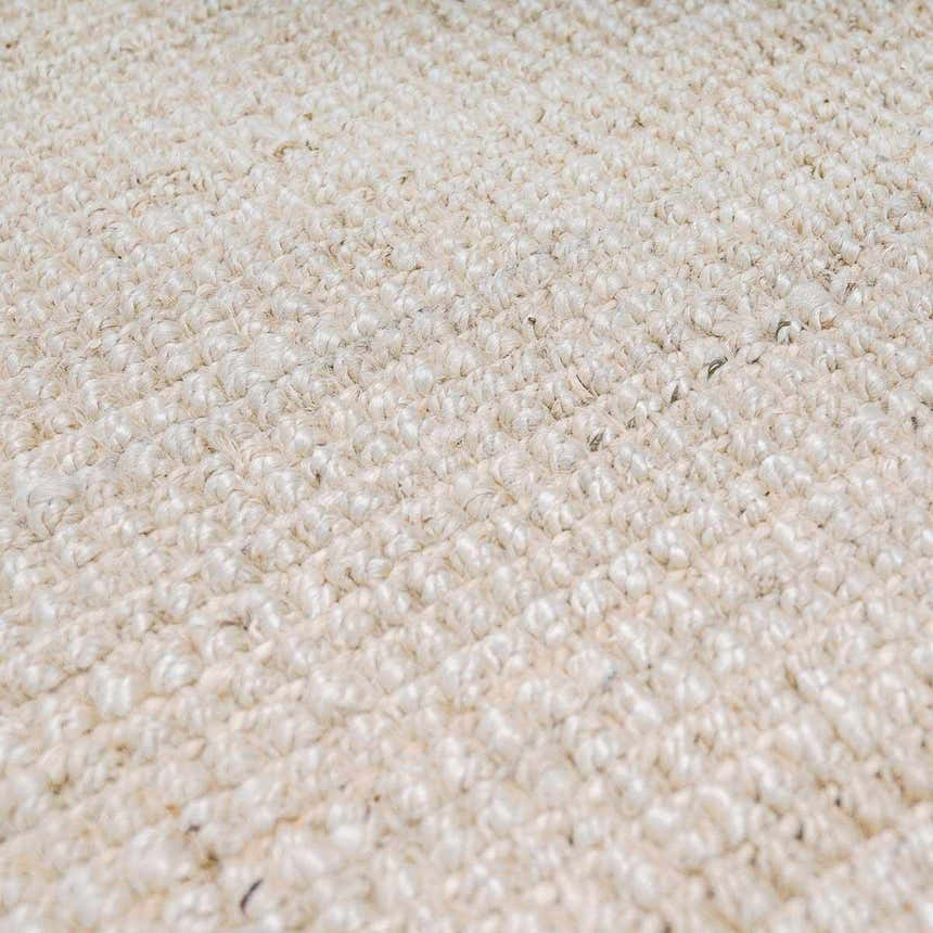 Close-up of the hand-woven Ambel Cream Jute Rug. Bone and beige tones highlight the rug's texture and natural jute fibers. Texture