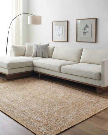 Living room with a Kenyi Camel Area Rug, white sectional sofa, wood floors, and modern artwork. Roomscene-Rectangle