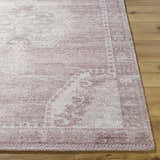 Close-up of the hand-tufted Alafin Area Rug. Features blush, cream, and mauve tones with a traditional pattern. Front