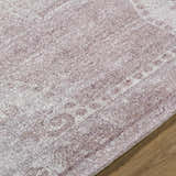 Close up of the hand tufted Alafin Area Rug. Colors include blush, cream, dusty rose, and mauve. Texture