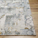 Close-up of the Adlai Textured Rug. The rug features a contemporary design with dusty sage, ink blue, and mustard accents. Front