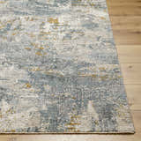 Close-up of the Chaya Textured Abstract Rug. Features dusty sage, ink blue, mustard, and gray tones. Modern design. Front