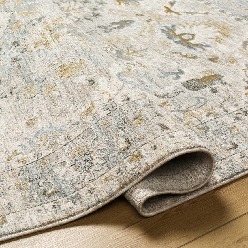 Close-up of the Emile Textured Rug with Fringes showing its off-white, gray, and mustard traditional pattern and textured weave. Fold