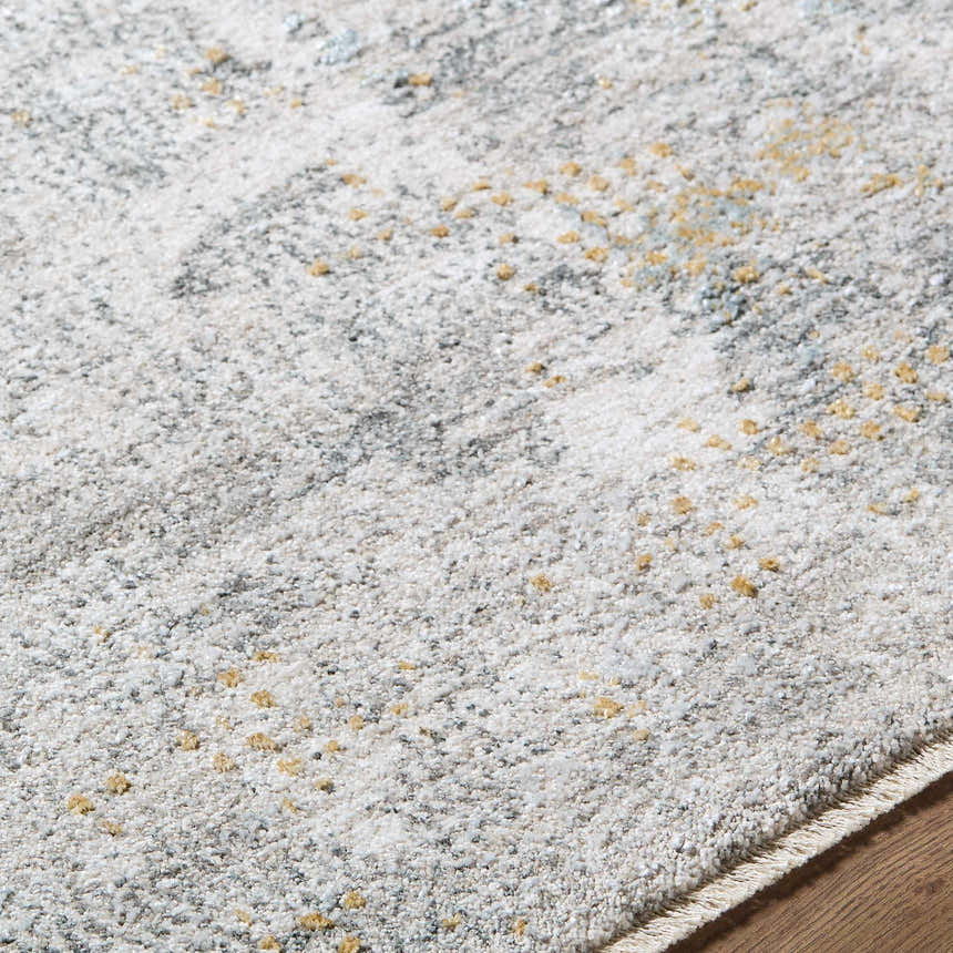 Close-up of the Gryta Textured Rug. Multi brown, gray, and light gray tones with a subtle textured pattern. Texture