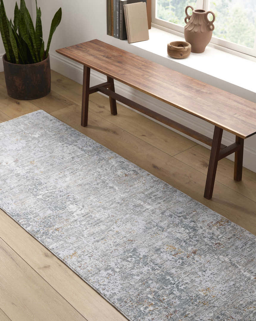 Entryway with wood bench and light wood floors featuring the Ifama Textured Rug in gray. Roomscene-Runner