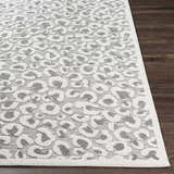 Close-up of Seascale Outdoor Carpet. Gray leopard print on a textured white background. Contemporary animal style. Front