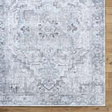 Close-up of Nadia Silver Gray Area Rug, showing traditional light purple, silver gray pattern and machine woven texture. Corner