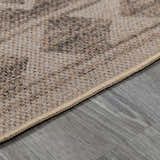 Close-up of the beige and brown patterned Halle Beige Washable Area Rug showing woven texture and neutral tones. Pile