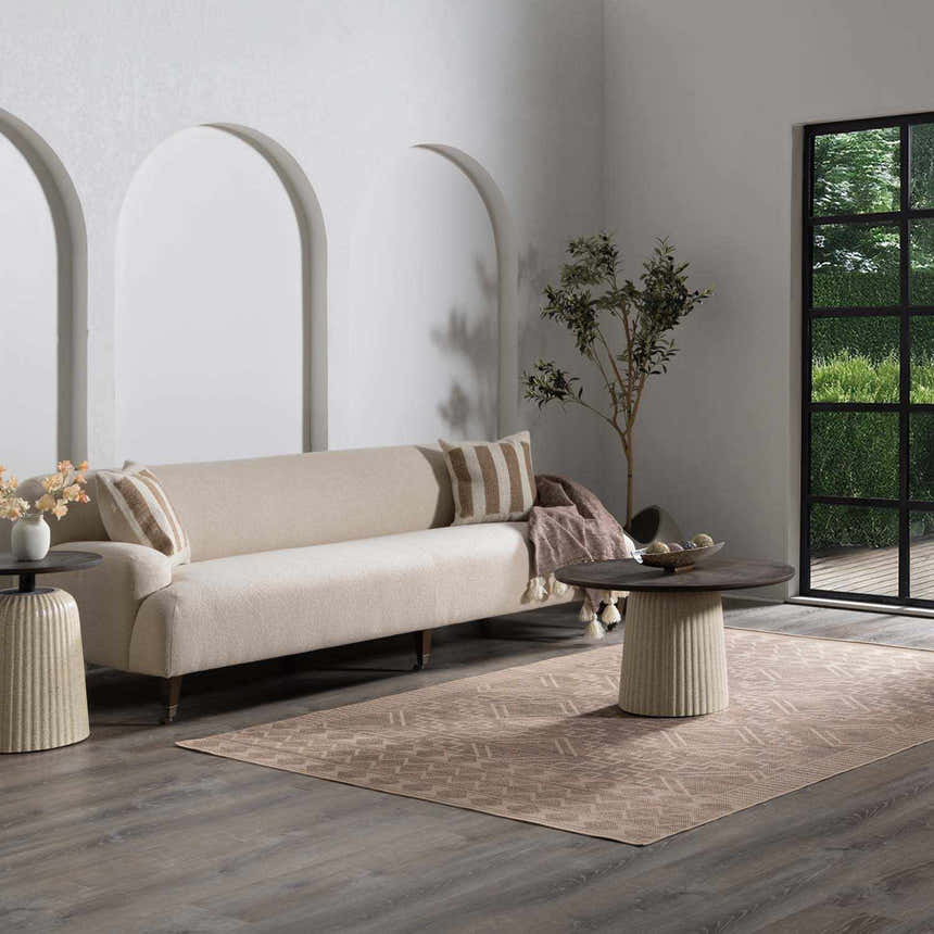 Living room scene with beige sofa and Halle Beige Washable Area Rug, a traditional style rug with a subtle geometric pattern. Roomscene-Rectangle