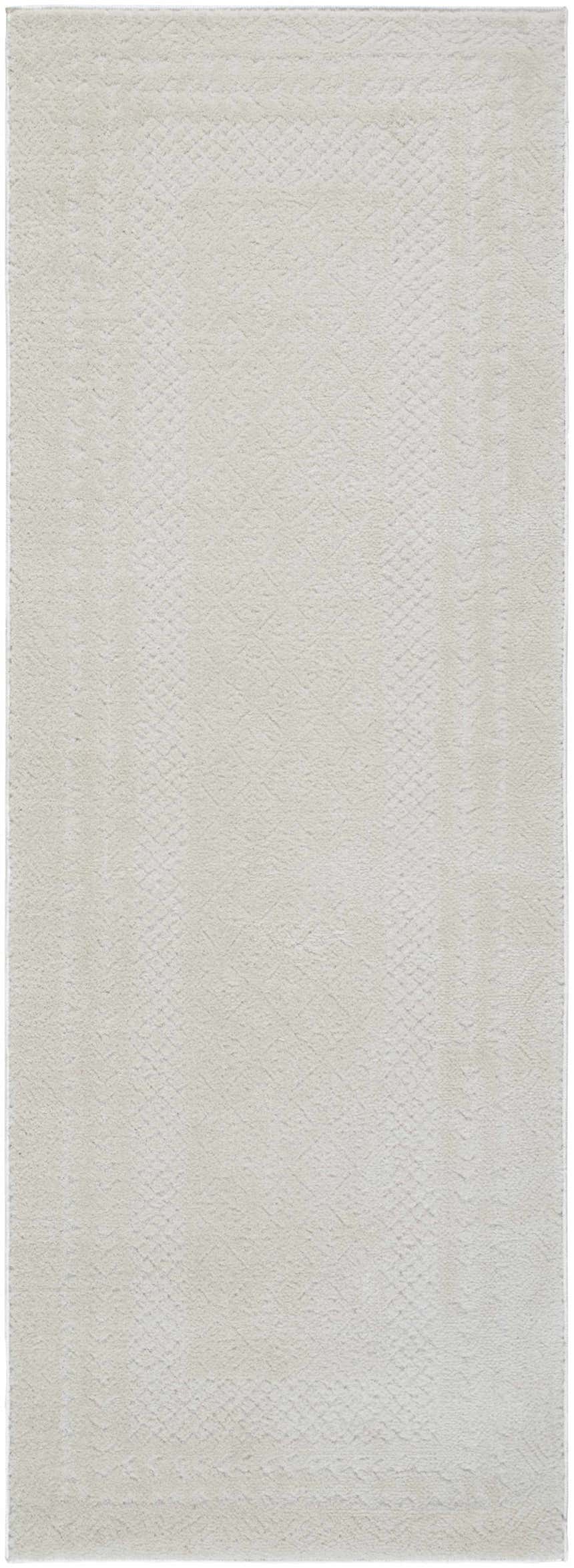 Close-up of the ivory Julio Area Rug, showcasing its subtle geometric pattern and soft, textured weave. Design-Runner-273
