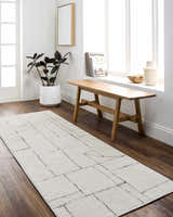 Bright entryway with a beige Keats Area Rug, wood bench, and white accents. Roomscene-Runner