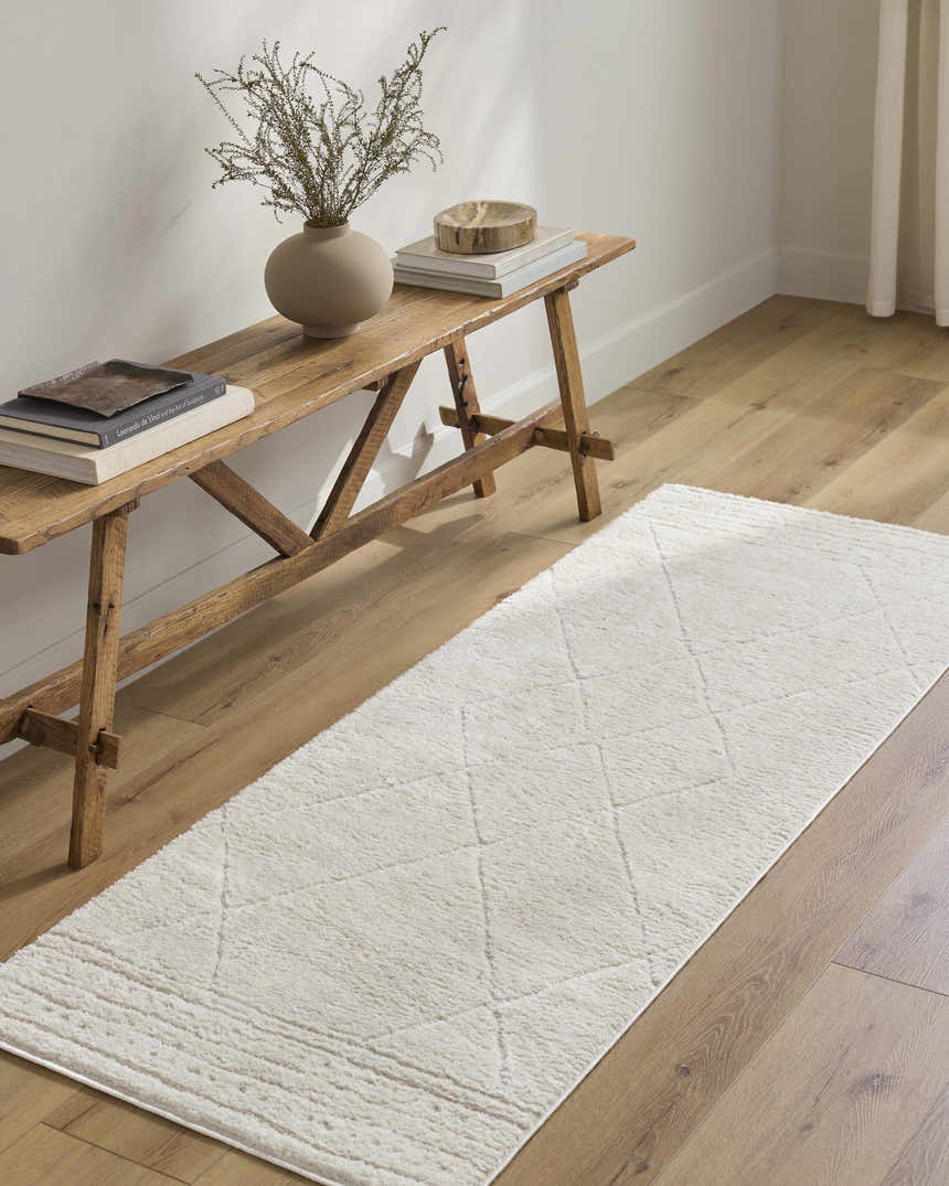 Entryway with a wooden bench and the ivory Keone runner rug on light wood floors. Roomscene-Runner