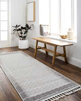 Entryway with wood bench and Ajda runner rug in beige and gray, styled with a plant and white decor. Roomscene-Runner