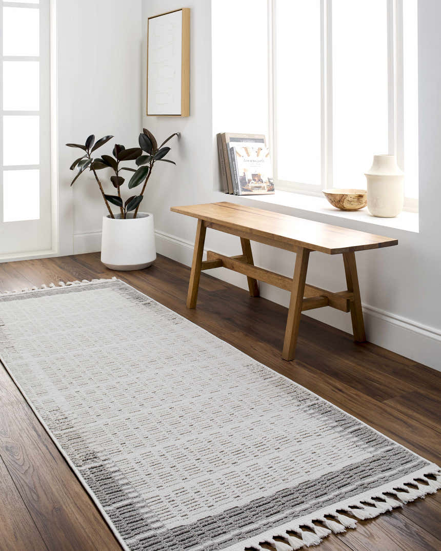 Entryway with wood bench and Ajda runner rug in beige and gray, styled with a plant and white decor. Roomscene-Runner