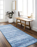 Bright hallway with blue Blake Arctic Sky Washable Area Rug, wood bench, plant, and natural light. Roomscene-Runner