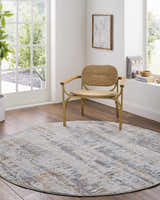Light and airy room featuring a round Guoda Area Rug in driftwood, gray, and nutmeg tones under a modern woven chair. Roomscene-Round