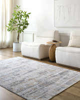 Living room scene with a Guoda Area Rug in driftwood, gray, and brown tones, paired with white chairs and light wood floors. Roomscene-Rectangle