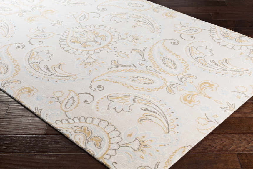 Close-up of Simpatico Candice Olson x LIVABLISS SPO-1001 rug. Cream rug with light blue, mustard, and gray paisley pattern. Corner