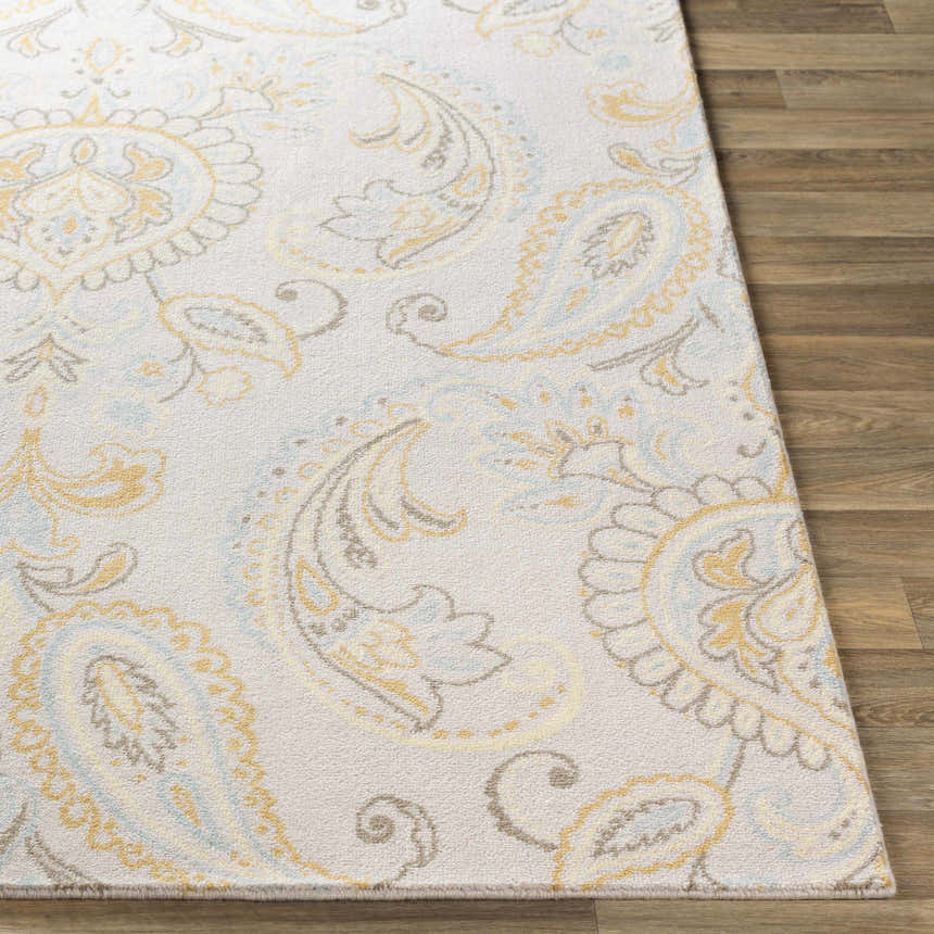 Close-up of Simpatico Candice Olson x LIVABLISS SPO-1001 rug. Cream rug with light blue, mustard, and gray paisley pattern. Front