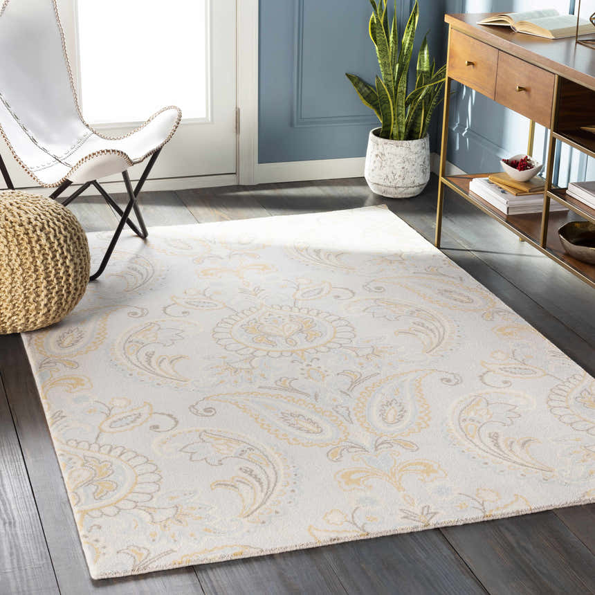 Living room scene with Simpatico Candice Olson x LIVABLISS SPO-1001 Area Rug, cream paisley pattern, white chair, and wood console. Roomscene-Rectangle