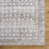 Close up of the Mabyn Area Rug showing its detailed, vintage-inspired pattern and soft polyester texture. Corner