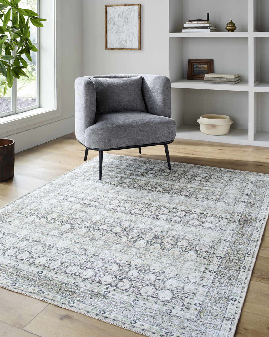 Living room scene with gray chair and neutral Mabyn Area Rug on wood floor. Roomscene-Rectangle