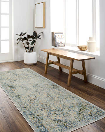 Hallway scene with Aurum Beige Washable Area Rug, wood floors, bench, plant, and bright natural light from a large window. Roomscene-Runner