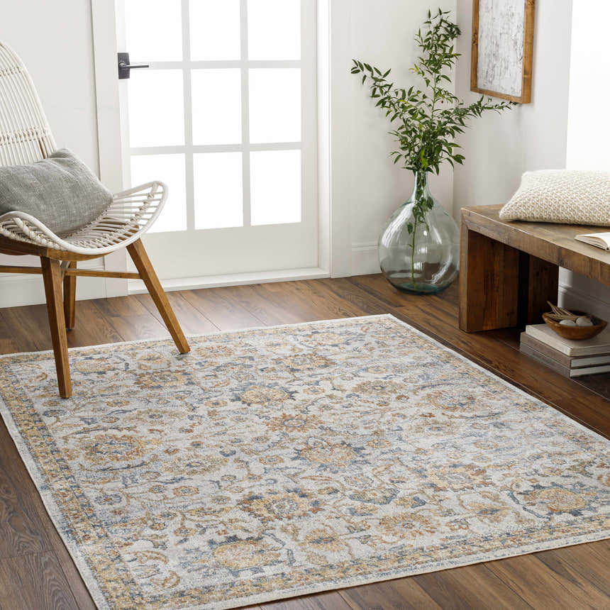 Entryway with Dion Washable Floral Rug in driftwood, beige, and blue. Features a white chair and wooden bench. Roomscene-Rectangle
